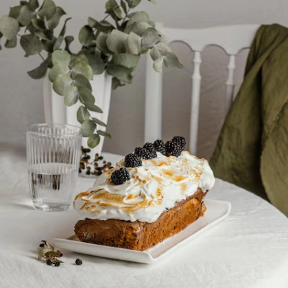 Delicious bun with whipped cream with blueberry topping